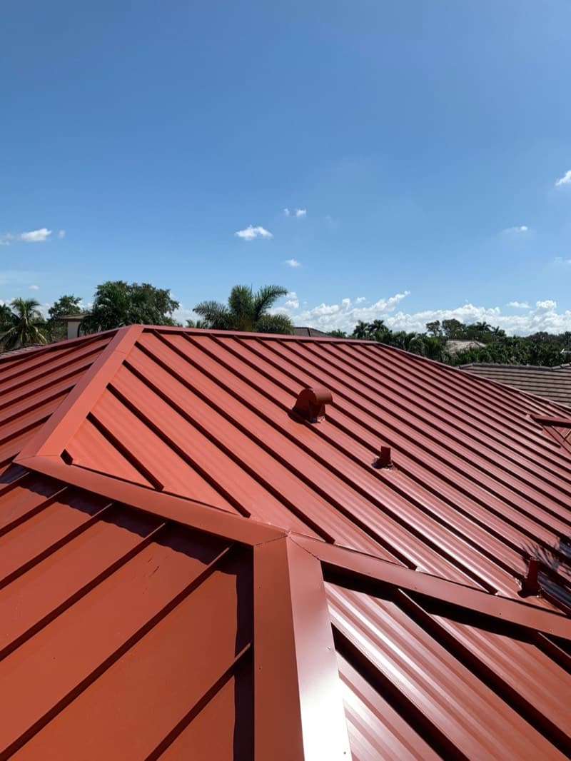 Red standing seam metal roof installation