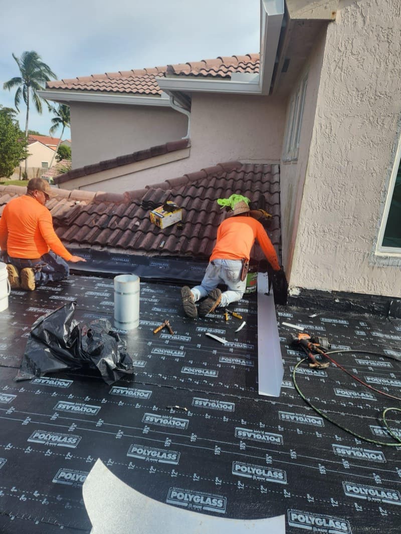 Crew installing tile on repaired area