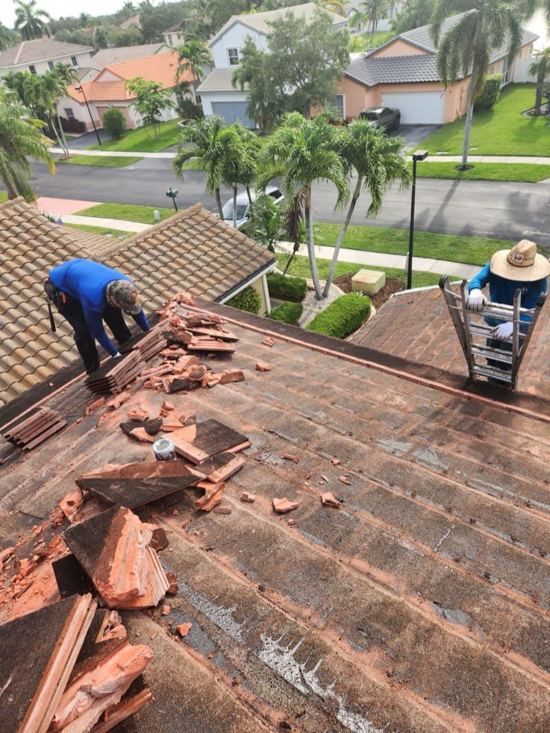Crew removing damaged tile for repair